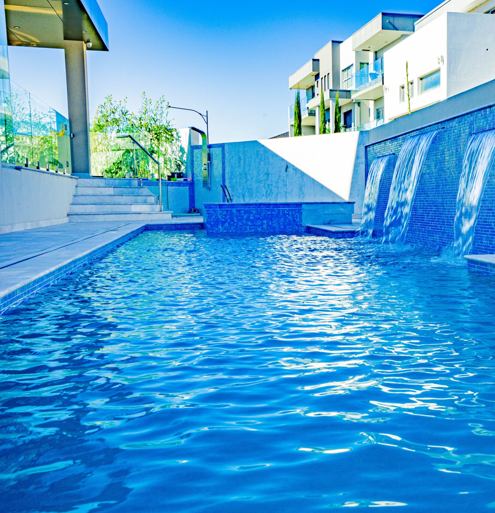 A pool with a cascading waterfall.